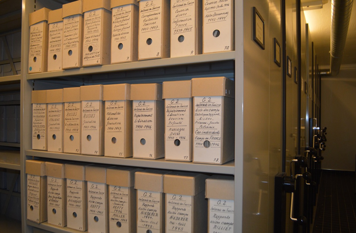 Archive shelving lined with labelled document boxes
